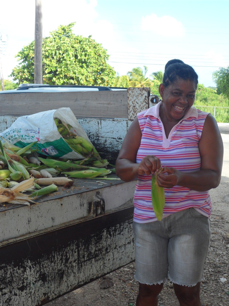 Lovely lady stripping corn in Anguilla