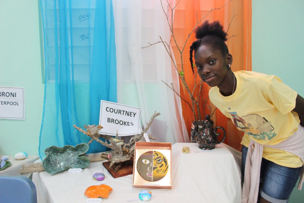 Courtney Brooks proudly displays her work at pottery exhibition